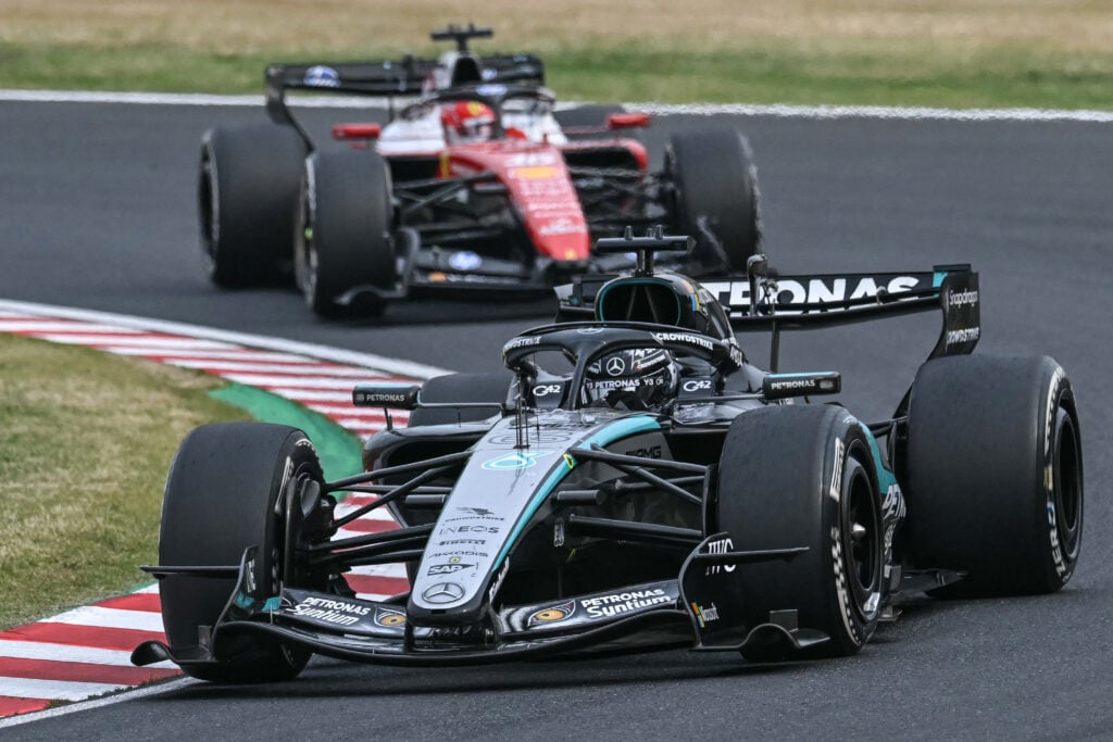 Mercedes' British driver George Russell drives followed by Ferrari's Monegasque driver Charles Leclerc during the Formula One Japanese Grand Prix at the Suzuka circuit in Suzuka, Mie prefecture on March 29, 2026.