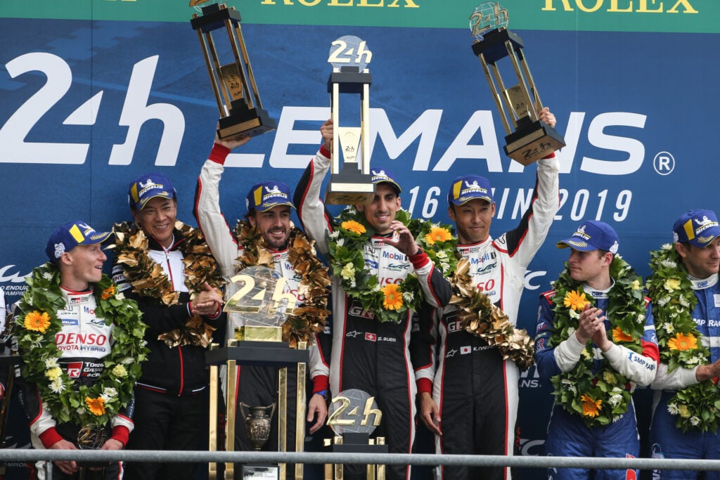 Fernando Alonso celebrates on the podium after winning the 2019 Le Mans 24 Hours for Toyota