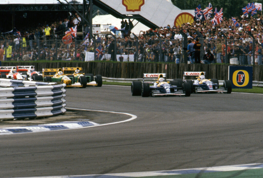 Williams driver Nigel Mansell fights teammate Riccardo Patrese on track during the 1992 F1 British Grand Prix at Silverstone