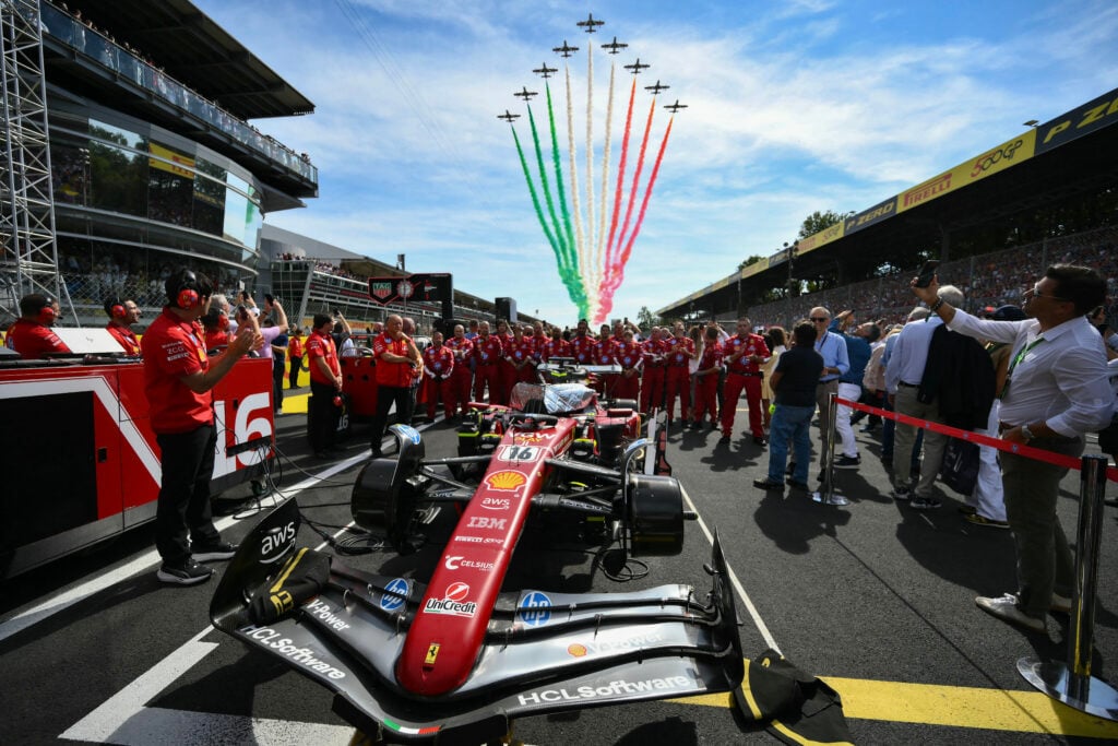 The Italian Air Force acrobatic unit Frecce Tricolori (Tricolored Arrows) performs a fly-over as Ferrari's Monegasque driver Charles Leclerc sits in his car on the grid prior to the Italian Formula One Grand Prix at the Autodromo Nazionale Monza circuit, in Monza, northern Italy, on September 7, 2025.