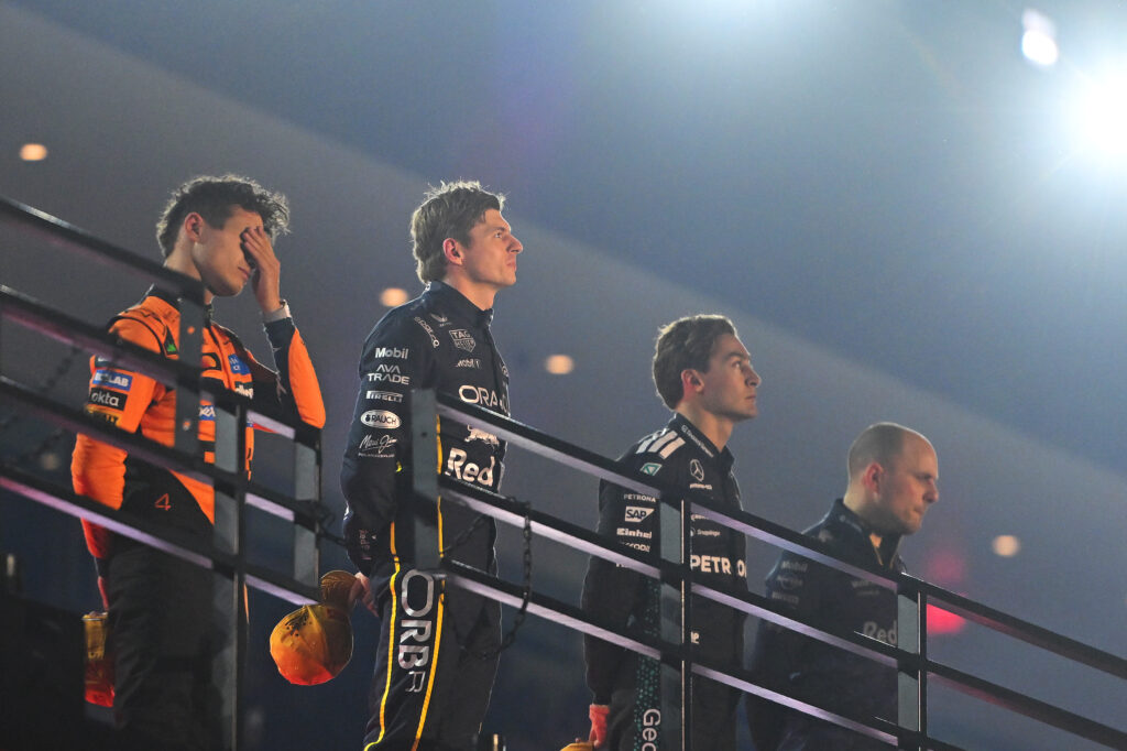 McLaren's Lando Norris, Red Bull's Max Verstappen and Gianpiero Lambiase and Mercedes' George Russell celebrate on the 2025 F1 Las Vegas Grand Prix podium