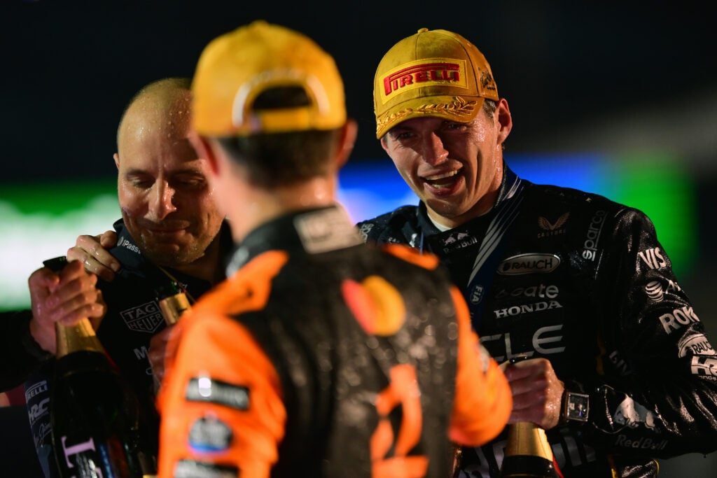 Race winner Max Verstappen of the Netherlands and Oracle Red Bull Racing Second placed Lando Norris of Great Britain and McLaren (later disqualified) and Gianpiero Lambiase, Head of Racing of Oracle Red Bull Racing celebrate on the podium during the F1 Grand Prix of Las Vegas at Las Vegas Strip Circuit on November 22, 2025 in Las Vegas, Nevada. McLaren drivers Lando Norris and Oscar Piastri were both later disqualified from the Las Vegas Grand Prix result after post-race checks found their cars did not to comply with technical regulations.
