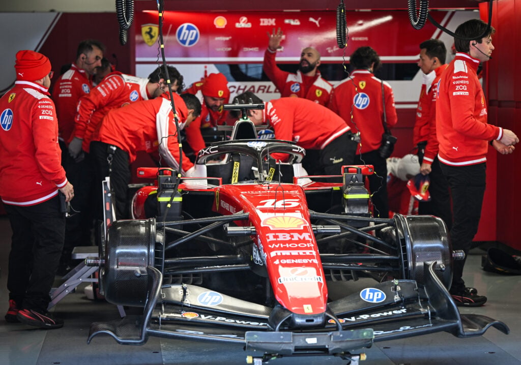 Ferrari engineers work on Charles Leclerc's car in the garage during Sprint Qualifying at the 2026 F1 Chinese Grand Prix