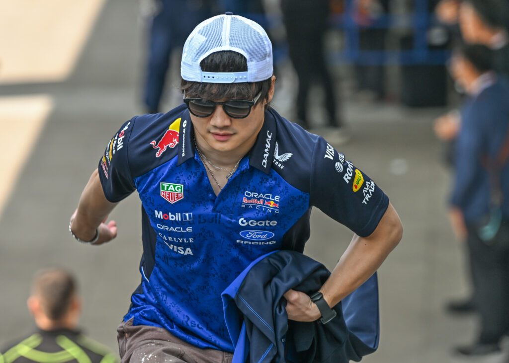 Yuki Tsunoda of Red Bull walks in the F1 paddock