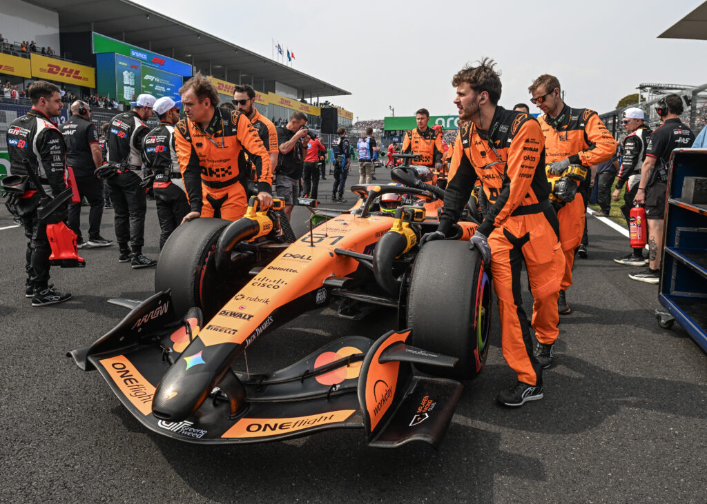 Team staff bring Oscar Piastri's McLaren F1 Team car to the start line ahead of the 2026 Japanese Grand Prix at Suzuka Circuit in Suzuka, Mie Prefecture, Japan, on March 29, 2026.