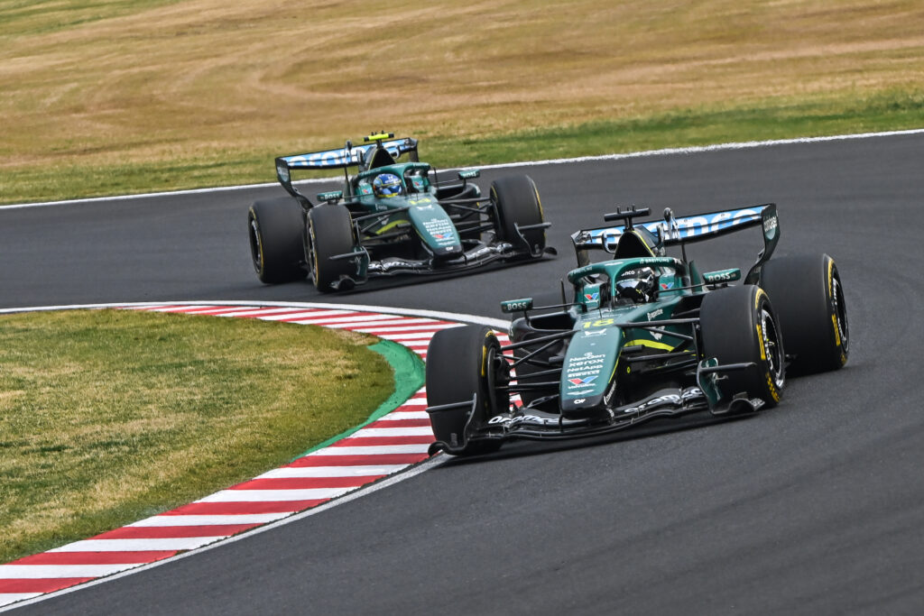Lance Stroll of Aston Martin leads Fernando Alonso