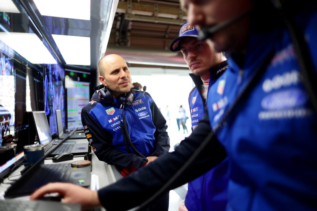 Red Bull head of racing Gianpiero Lambiase speaks with Max Verstappen in the garage during qualifying for the 2026 F1 Japanese Grand Prix