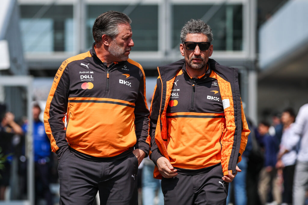 McLaren CEO Zak Brown speaks with team principal Andrea Stella in the paddock at the 2026 F1 Japanese Grand Prix