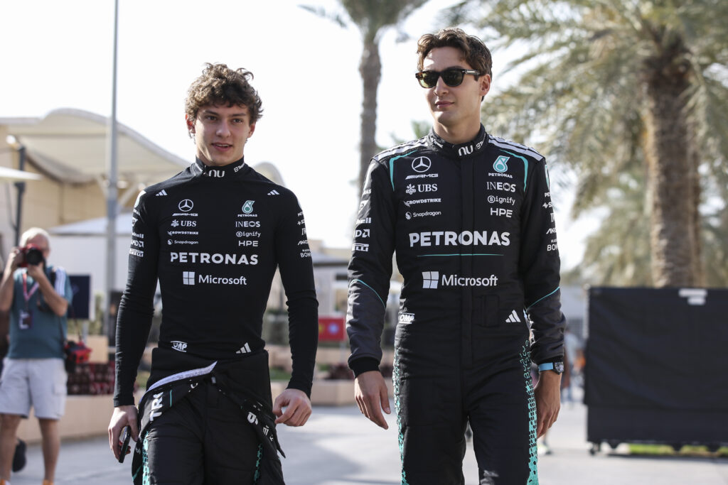 Kimi Antonelli and George Russell walking in the F1 Paddock