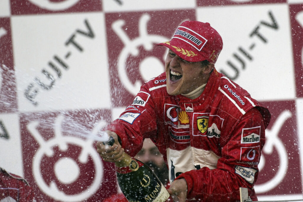 Ferrari driver Michael Schumacher celebrates after the 2002 F1 Japanese Grand Prix