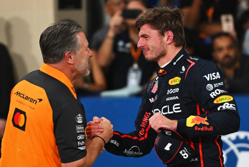McLaren CEO Zak Brown shakes hands with Max Verstappen after qualifying ahead of the Abu Dhabi Grand Prix.