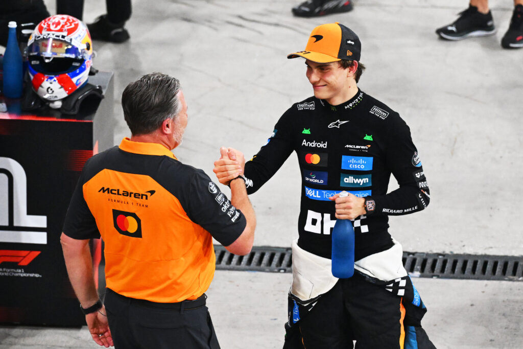 Oscar Piastri shaking hands with McLaren CEO Zak Brown after the Abu Dhabi Grand Prix.