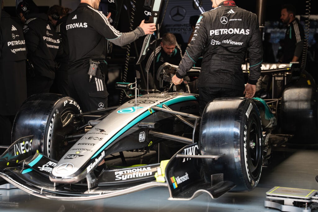 Mercedes-AMG Petronas engineers work on George Russell's car in the garage during the 2026 Chinese Grand Prix weekend.
