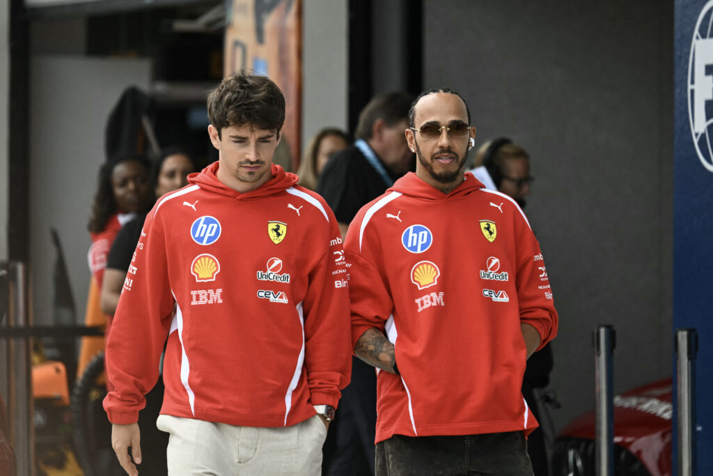 Ferrari's Monegasque driver Charles Leclerc and Ferrari's British driver Lewis Hamilton arrive for the Driver's Parade before the 2026 Miami Formula One Grand Prix at Miami International Autodrome in Miami Gardens, Florida, on May 3, 2026. Due to weather and timing, the Driver's Parade took place as a series of interviews near the garages instead of an on track parade.