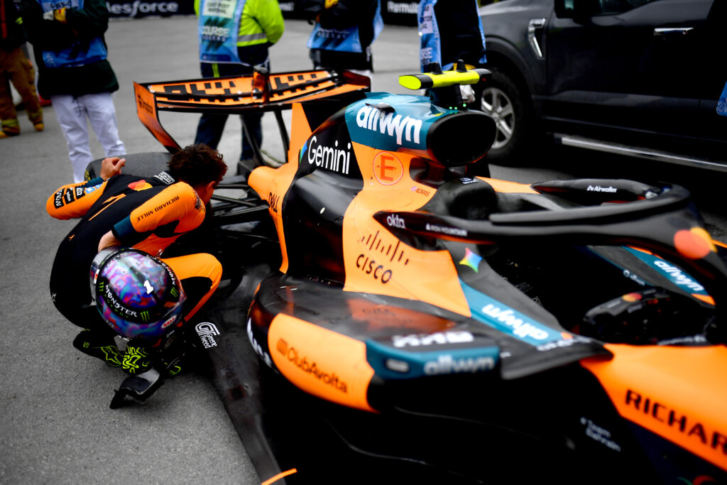 McLaren driver Lando Norris inspects the MCL40 after a DNF at the Canadian Grand Prix.