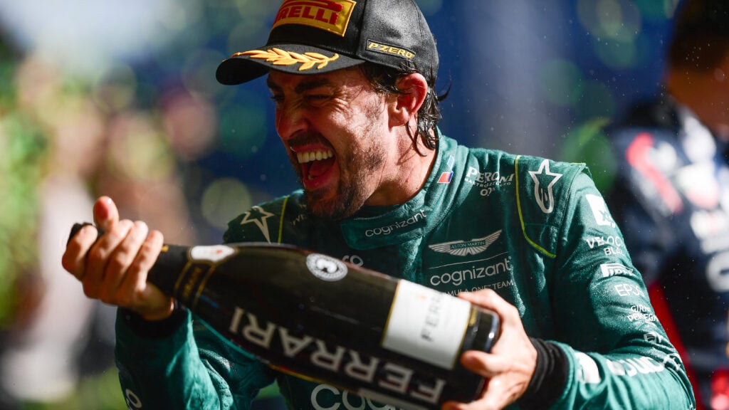 Fernando Alonso celebrating his P3 finish on the podium after the 2023 Sao Paulo Grand Prix.