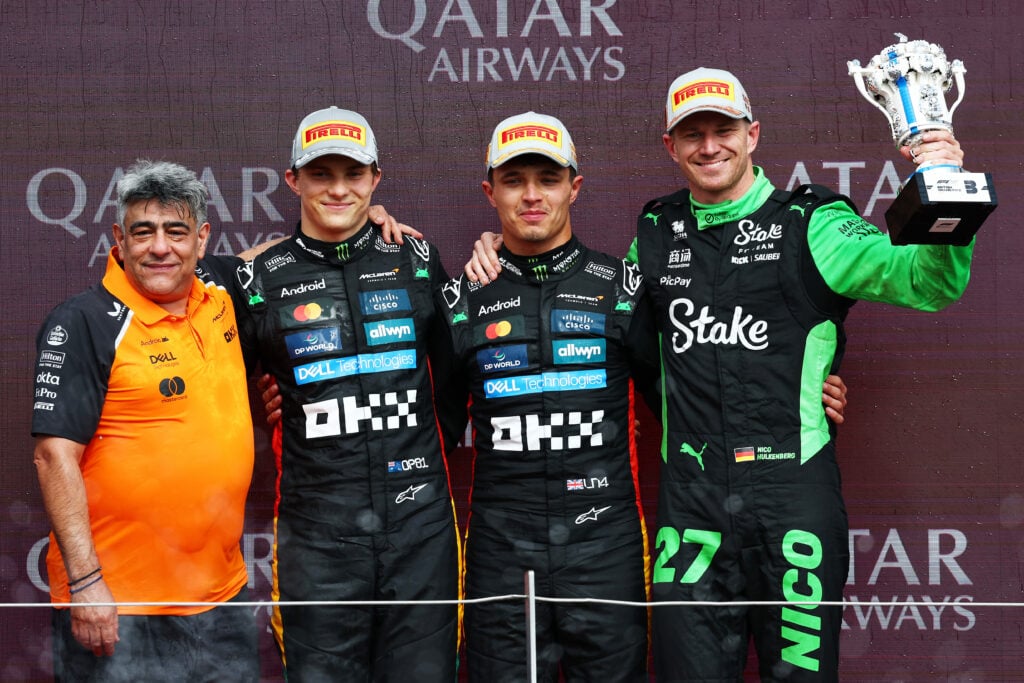 Lando Norris and Oscar Piastri of McLaren on the 2025 British Grand Prix podium with Nico Hulkenberg