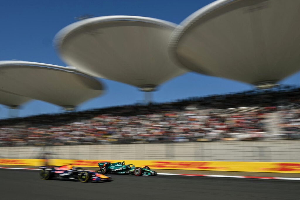 Red Bull driver Max Verstappen on track with Aston Martin's Fernando Alonso during qualifying for the 2026 MotoGP Chinese Grand Prix