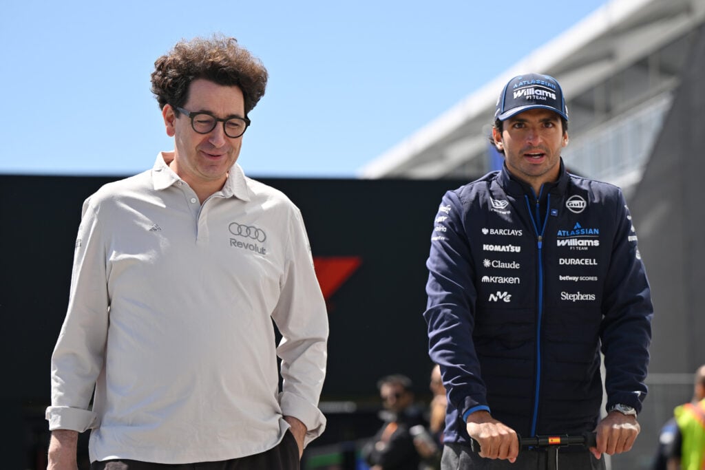 Audi F1 project lead Mattia Binotto speaks with Williams driver Carlos Sainz in the 2026 Canadian Grand Prix paddock