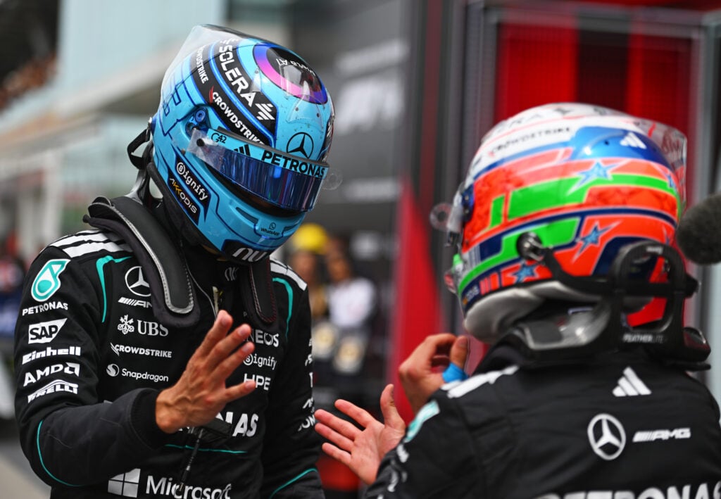 George Russell and Kimi Antonelli of Mercedes shake hands in parc ferme