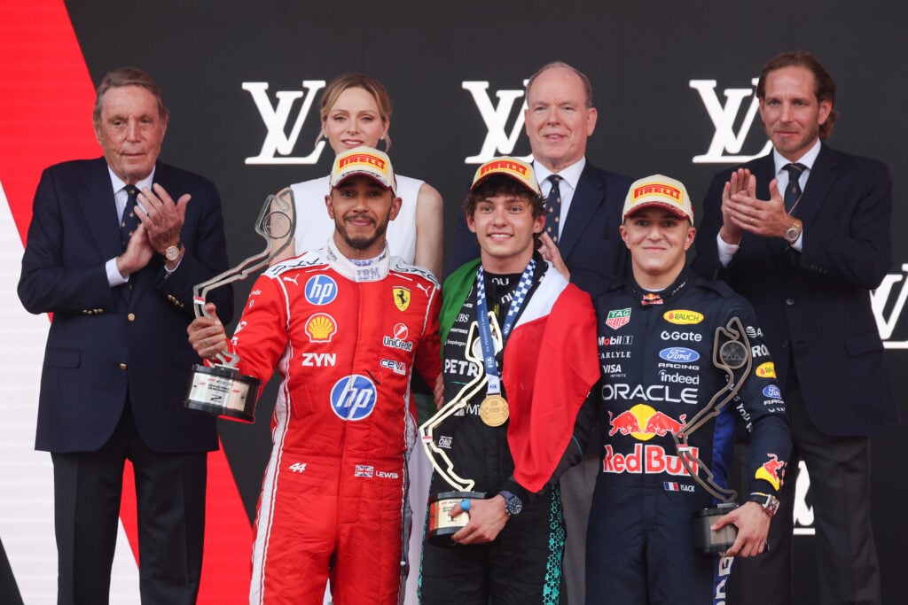 Lewis Hamilton of Ferrari, Kimi Antonelli of Mercedes, and Isack Hadjar or Red Bull on the podium after the Montreal Grand Prix.