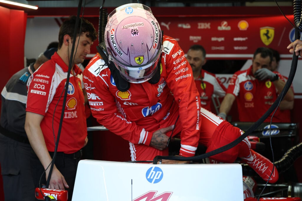 Lewis Hamilton of Ferrari exits his car in the Ferrari garage at the Monaco Grand Prix.