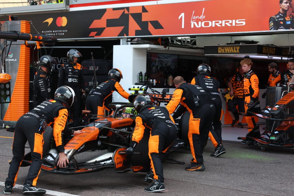 Lando Norris of McLaren has his car pulled back into the garage at the Monaco Grand Prix.
