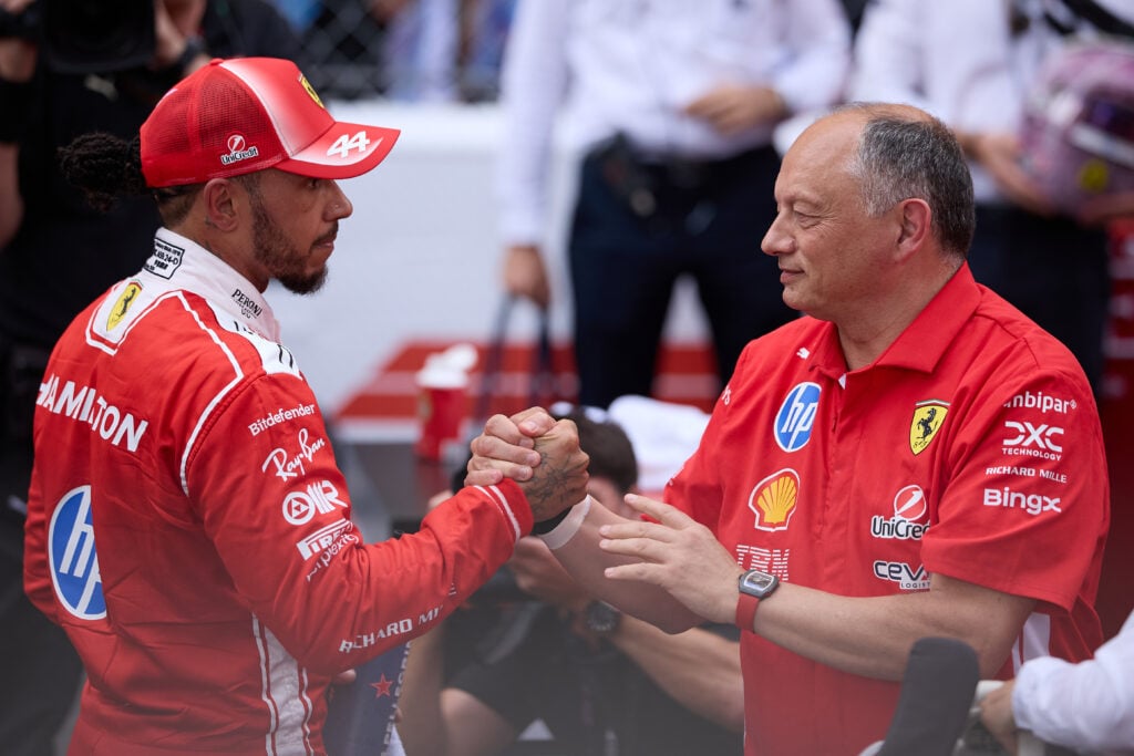 Ferrari driver Lewis Hamilton celebrates his P2 finish with team principal Fred Vasseur after the 2026 F1 Monaco Grand Prix