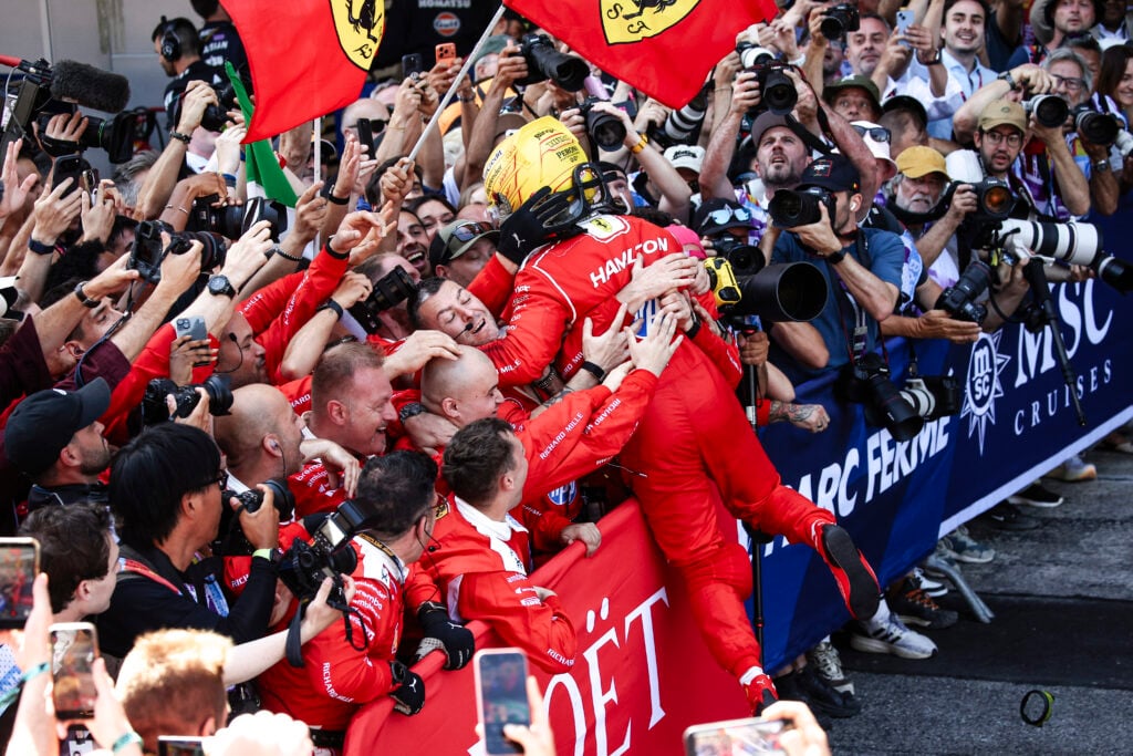 Lewis Hamilton celebrates with the Ferrari mechanics after winning the 2026 F1 Barcelona-Catalunya Grand Prix