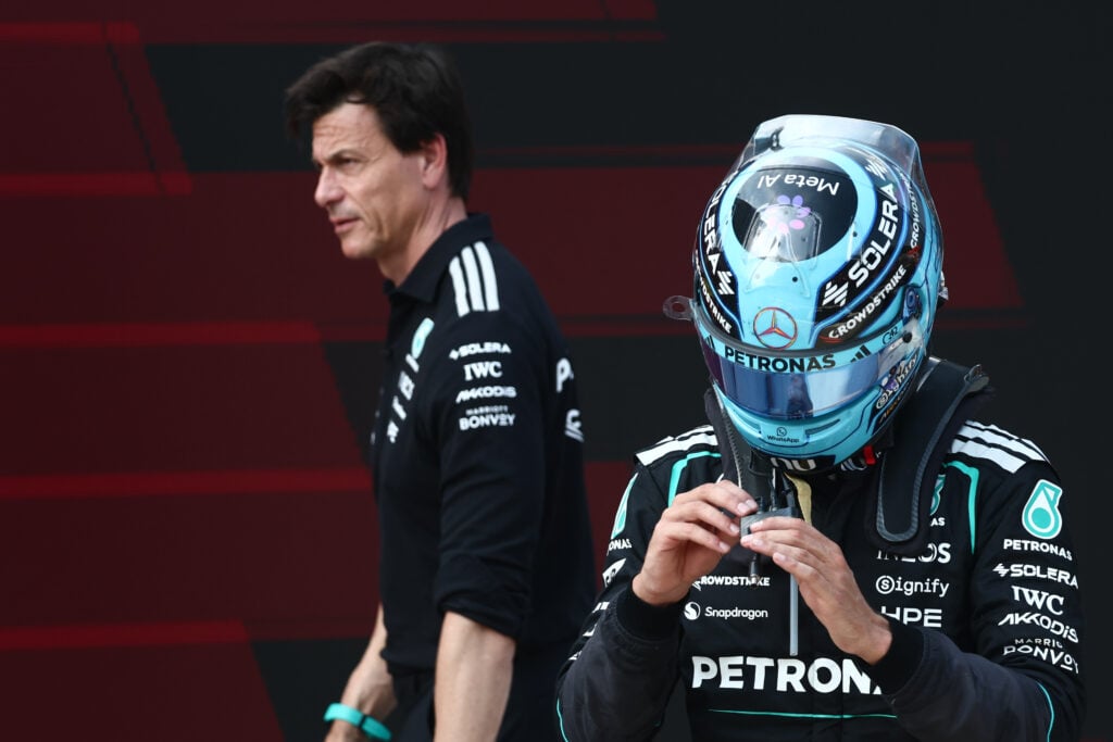 Mercedes CEO Toto Wolff walks past George Russell after the driver won the Austrian Grand Prix.
