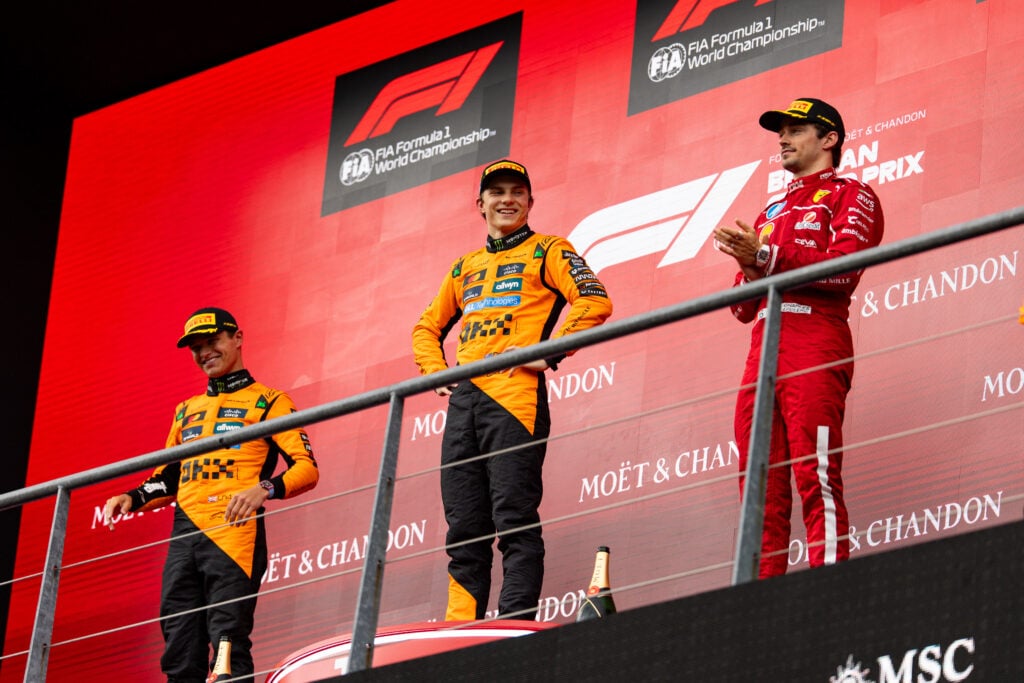 Oscar Piastri and Lando Norris of McLaren on the 2025 Belgian Grand Prix podium with Charles Leclerc of Ferrari