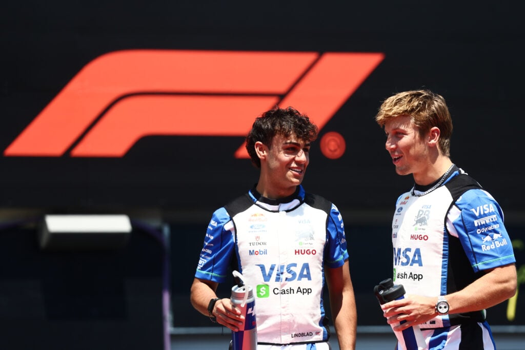 Racing Bulls drivers Arvid Lindblad and Liam Lawson speak in the 2026 F1 Austrian Grand Prix paddock