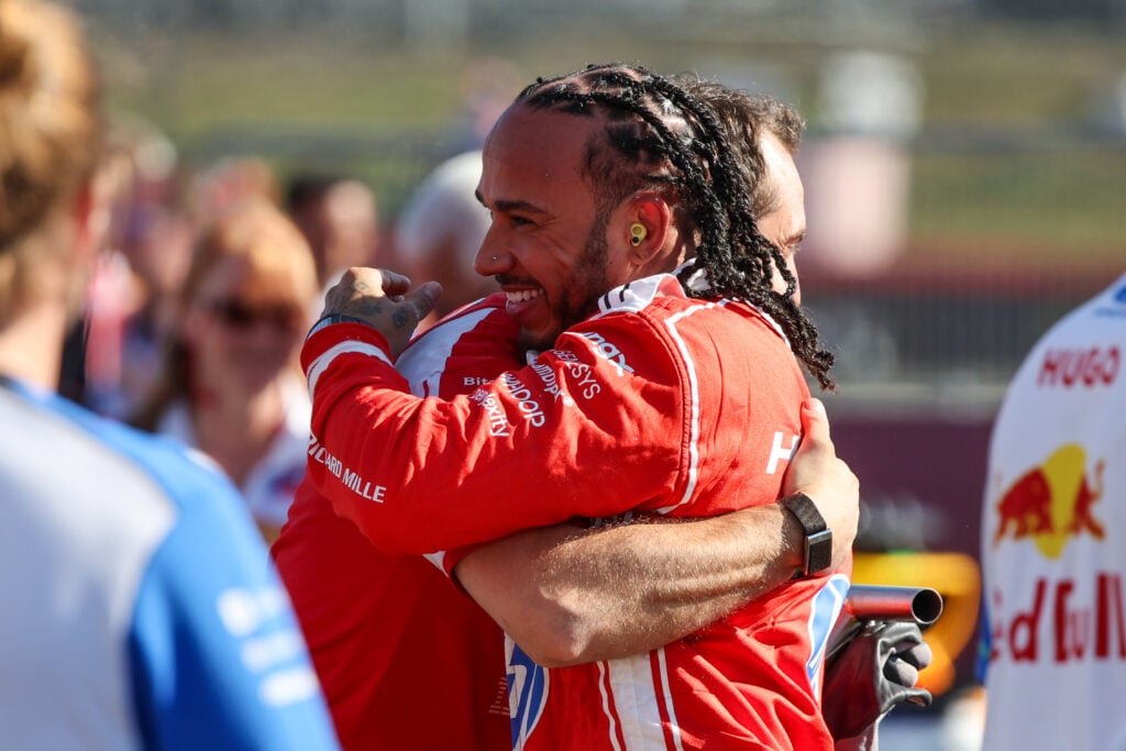 Lewis Hamilton hugging a Ferrari engineer after claiming pole position for the 2026 British Grand Prix Sprint.