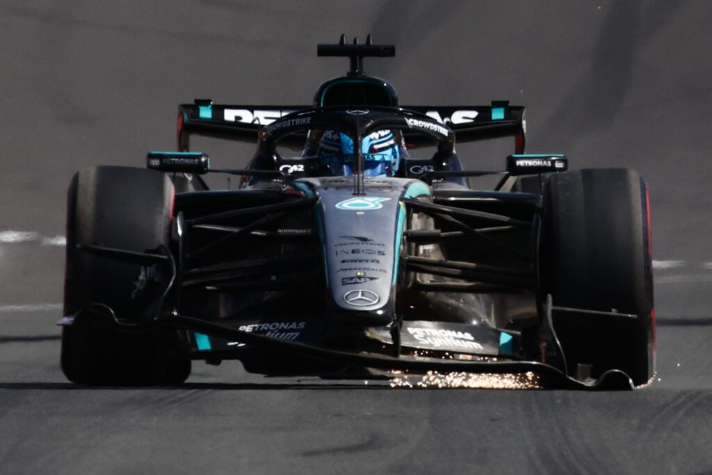 George Russell driving his Mercedes F1 car with a broken front wing at the 2026 British Grand Prix.