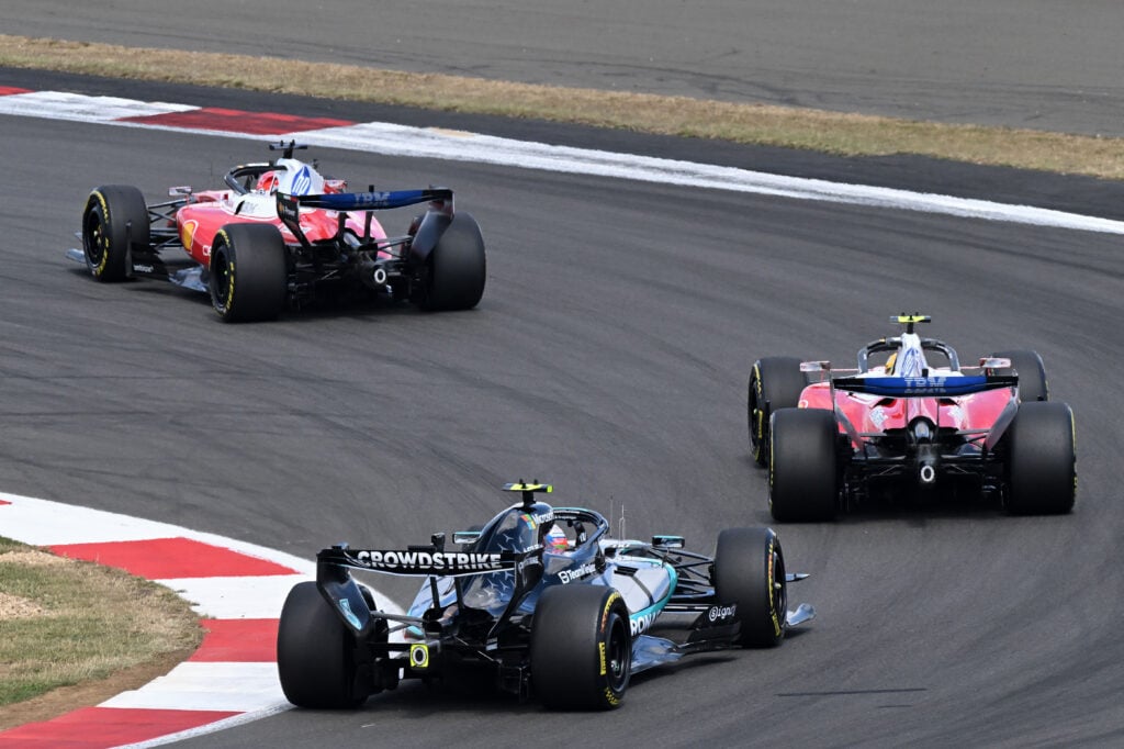 Charles Leclerc and Lewis Hamilton of Ferrari lead Mercedes driver Andrea Kimi Antonelli on track during the 2026 F1 British Grand Prix