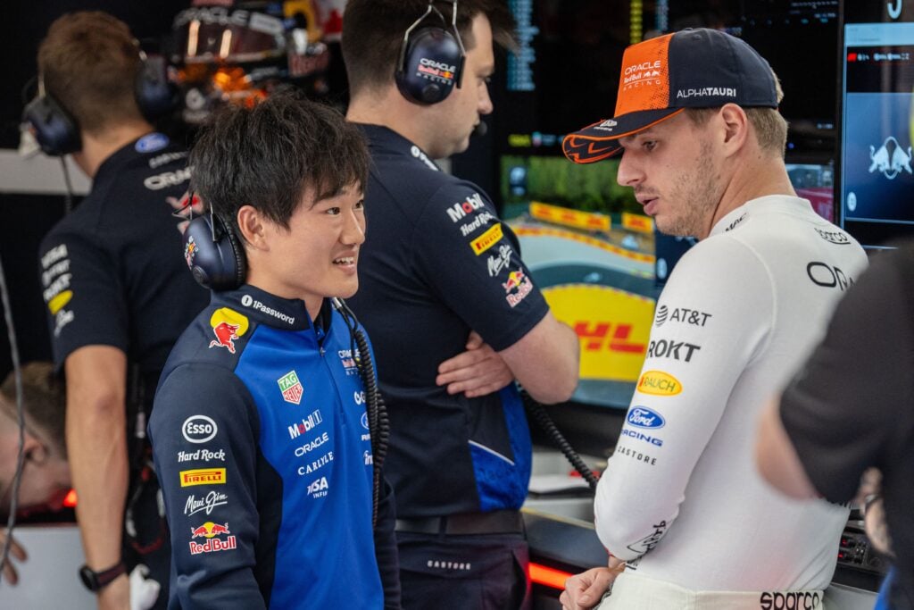 Red Bull reserve driver Yuki Tsunoda speaks to Max Verstappen in the Red Bull garage ahead of the Belgian Grand Prix.