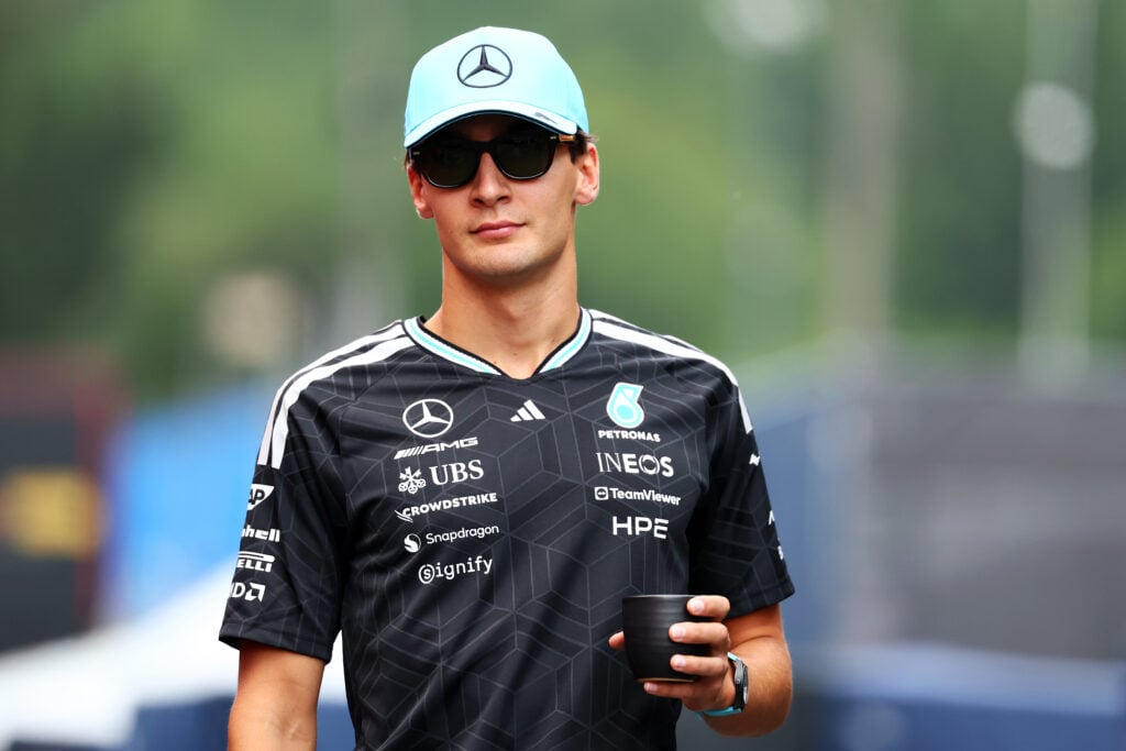 George Russell of Mercedes walks in the Belgian Grand Prix paddock
