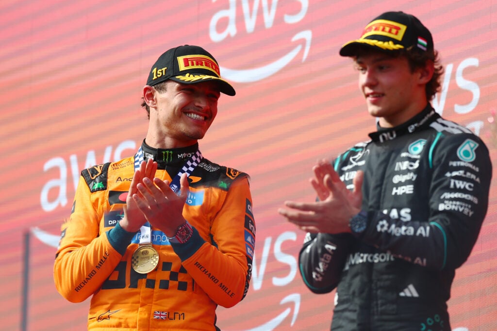 McLaren driver Lando Norris celebrates winning the 2026 F1 Hungarian Grand Prix on the podium with Mercedes' Andrea Kimi Antonelli
